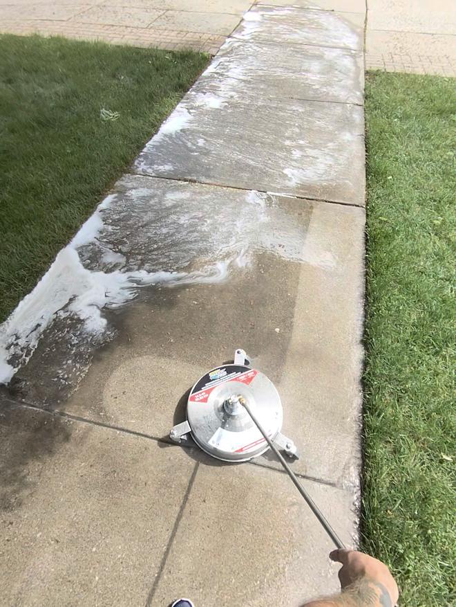 Power washing a sidewalk with a surface cleaner